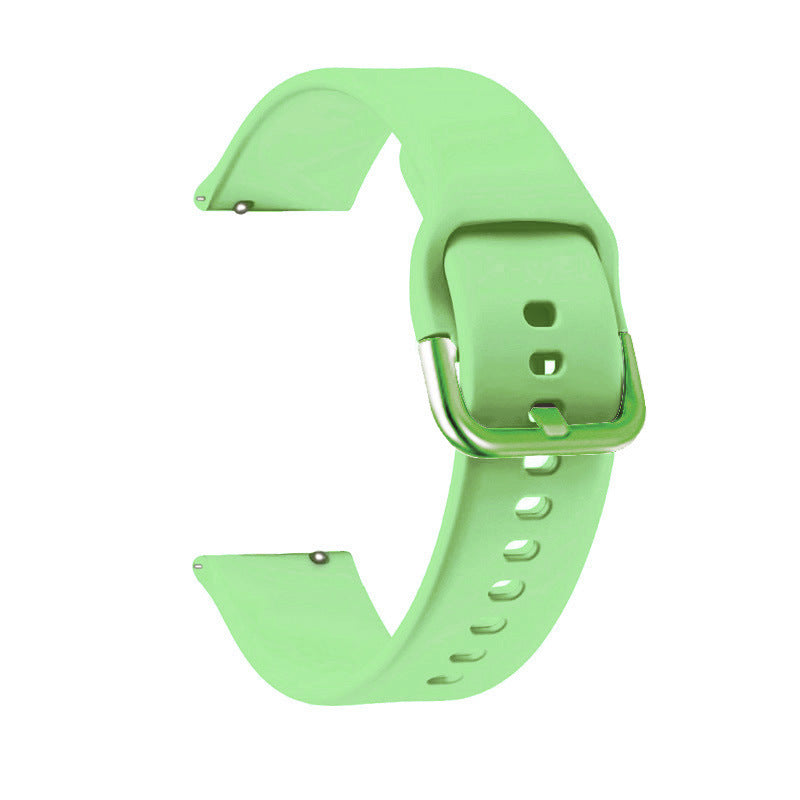Bright green silicone smartwatch band with quick release pins and adjustable buckle closure