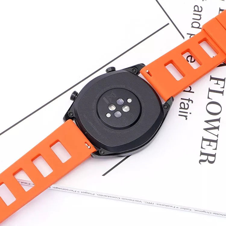 Orange silicone quick release watch band with black digital smartwatch face and ventilation holes