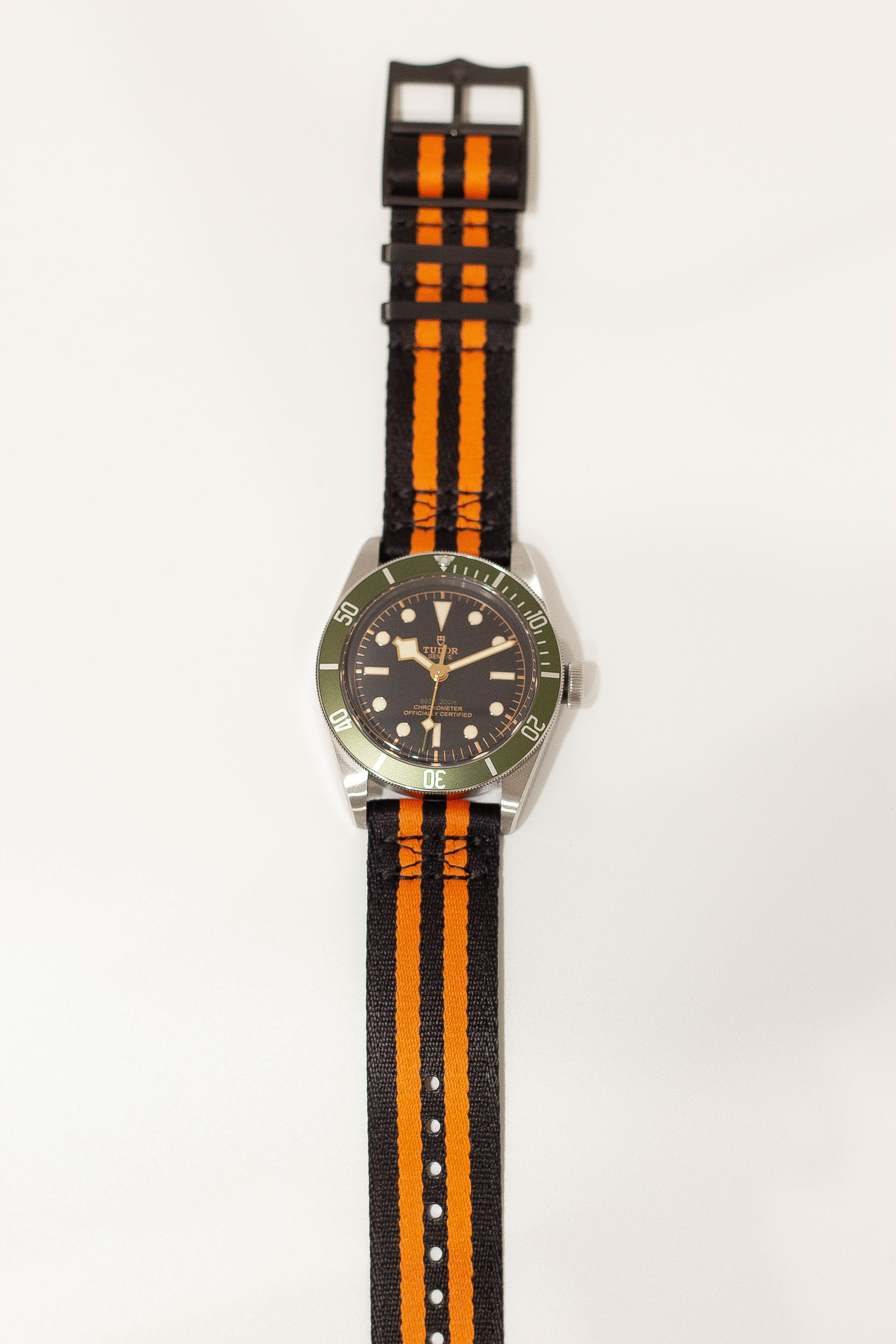 Military watch with black and orange strap