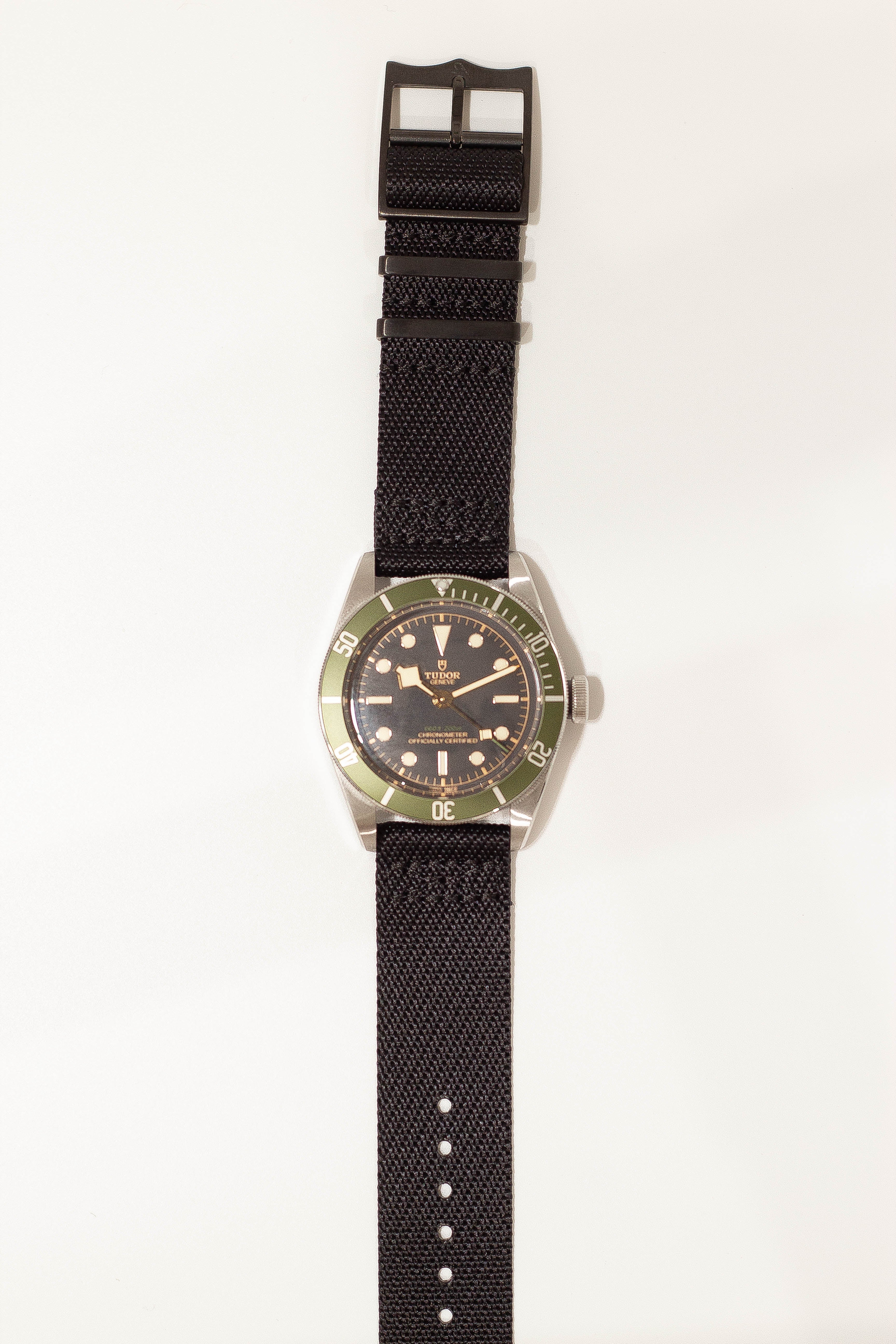 Tudor Black Bay dive watch on black fabric strap with quick release hardware