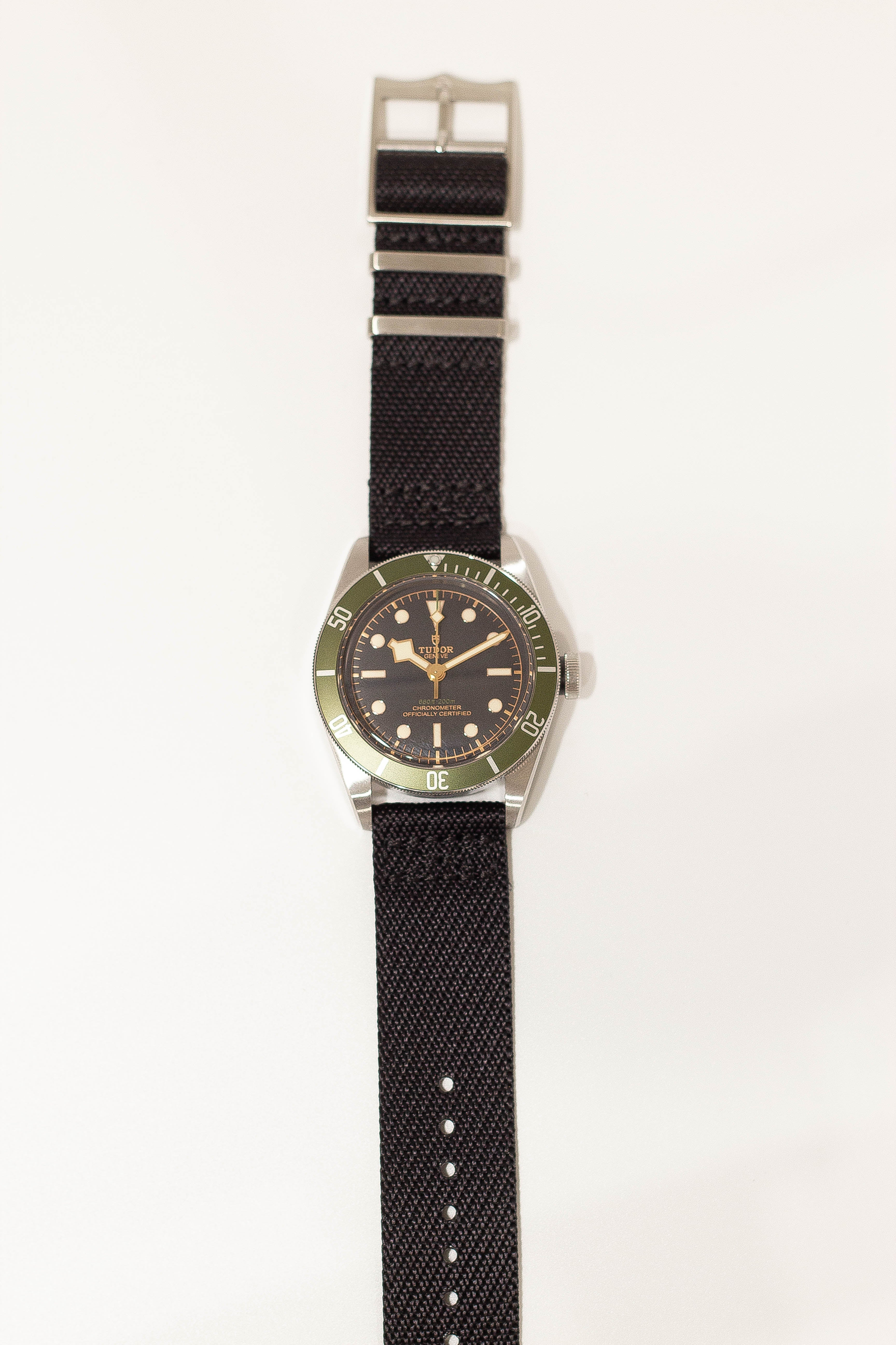 Tudor dive watch with black fabric strap quick release