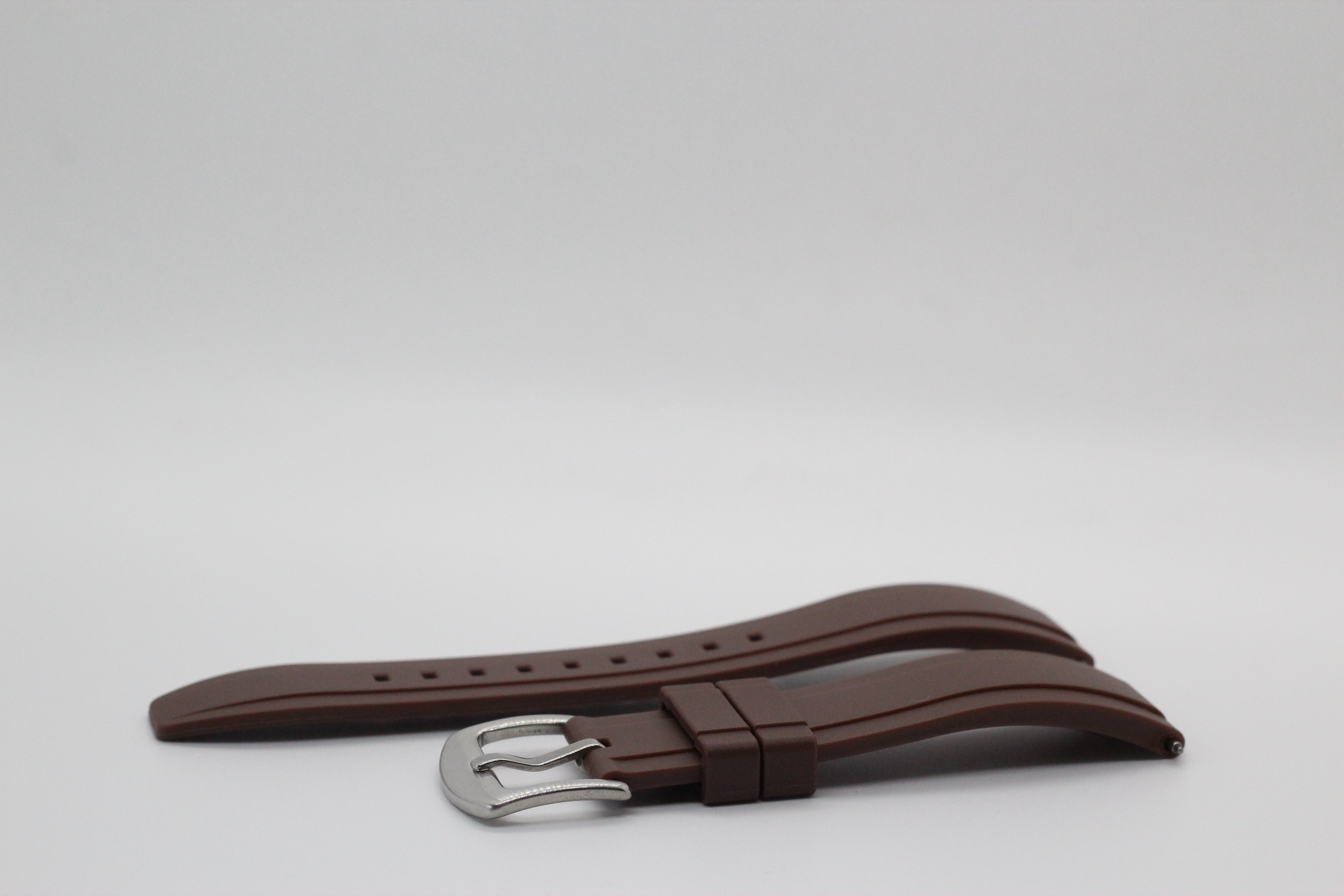 Brown leather watch strap with quick release mechanism and silver buckle fastener