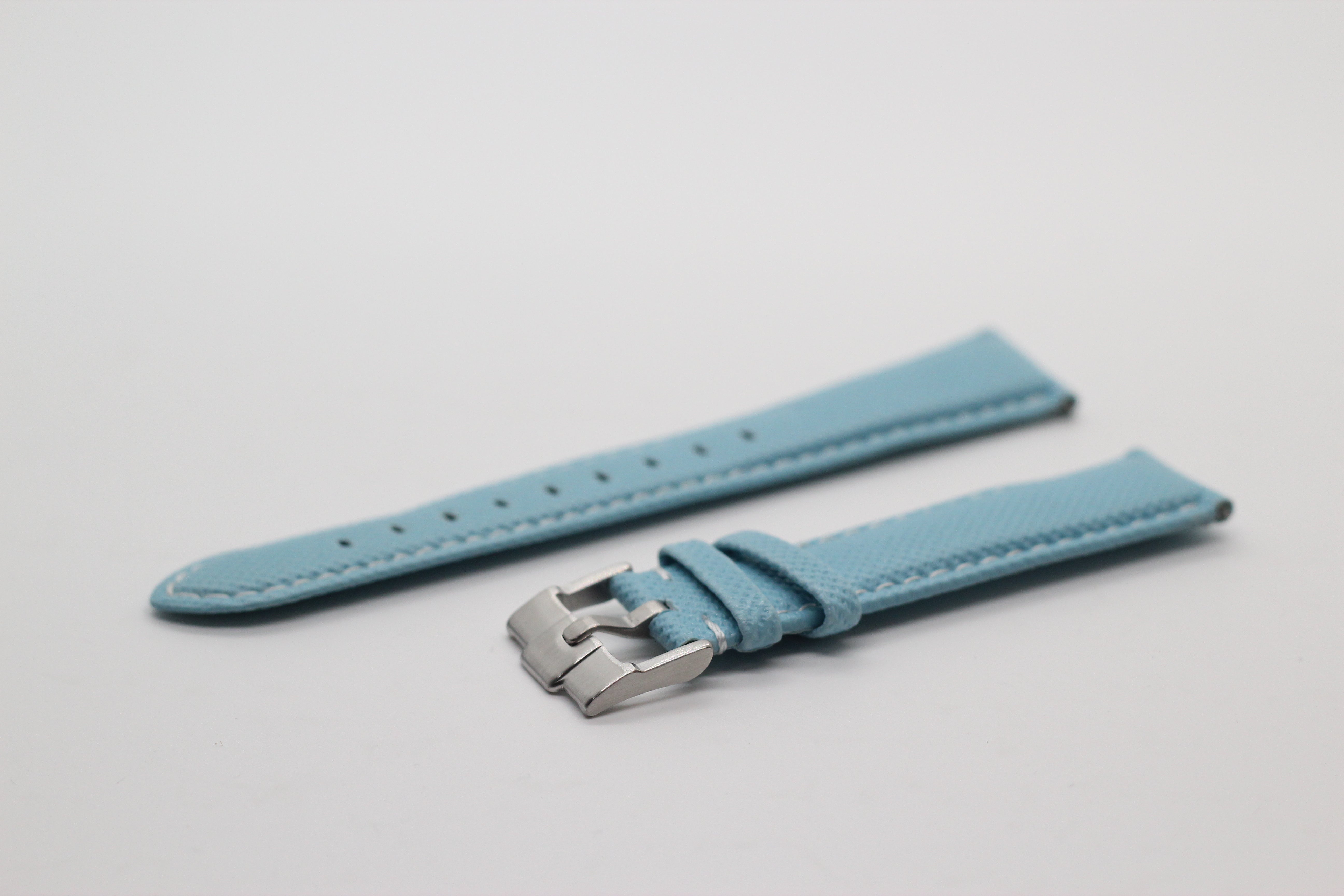 Light blue sailcloth quick release watch strap with white stitching and stainless steel buckle clasp