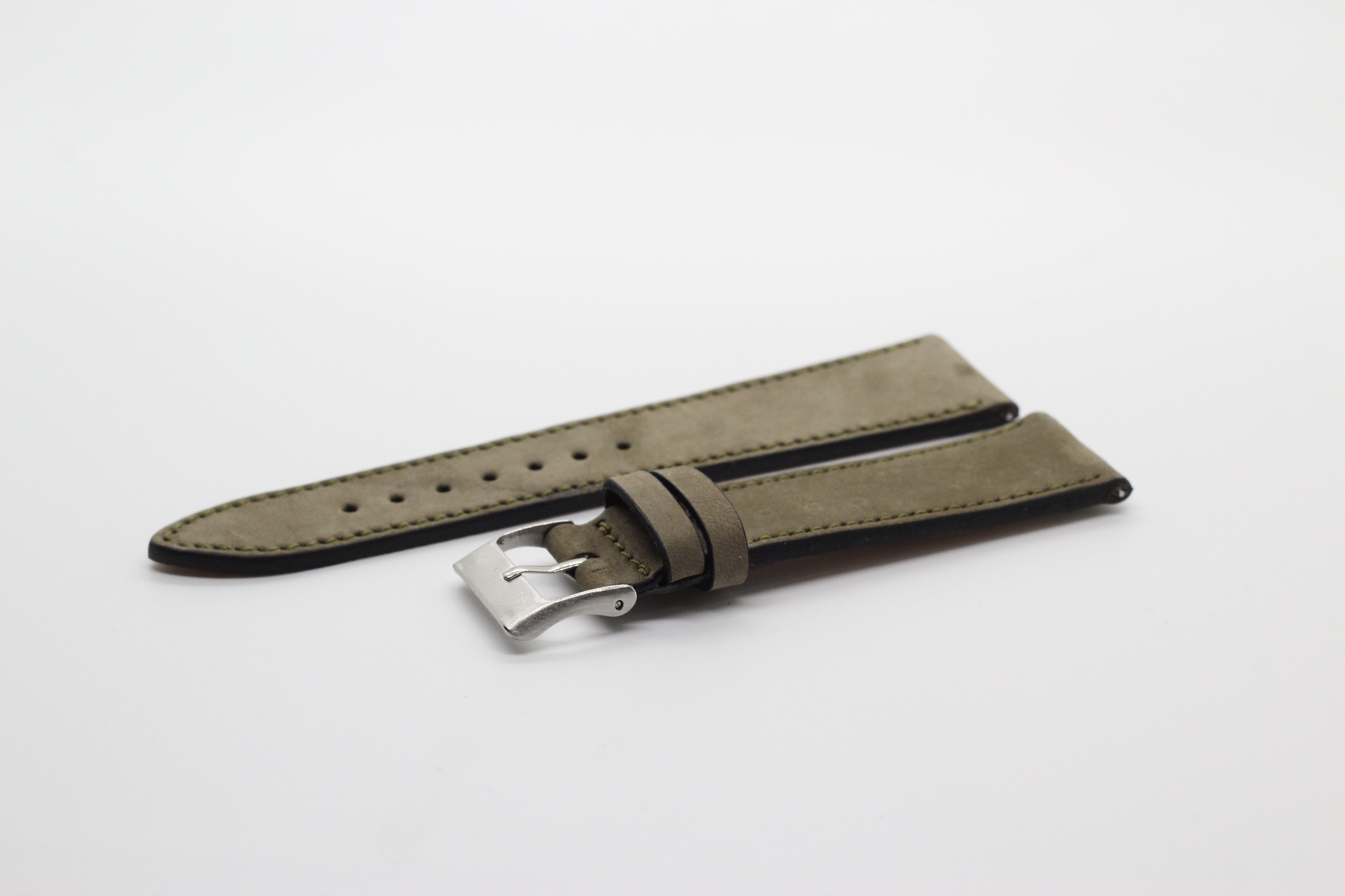 Olive green nubuck leather quick release watch strap with silver buckle and black edge lining