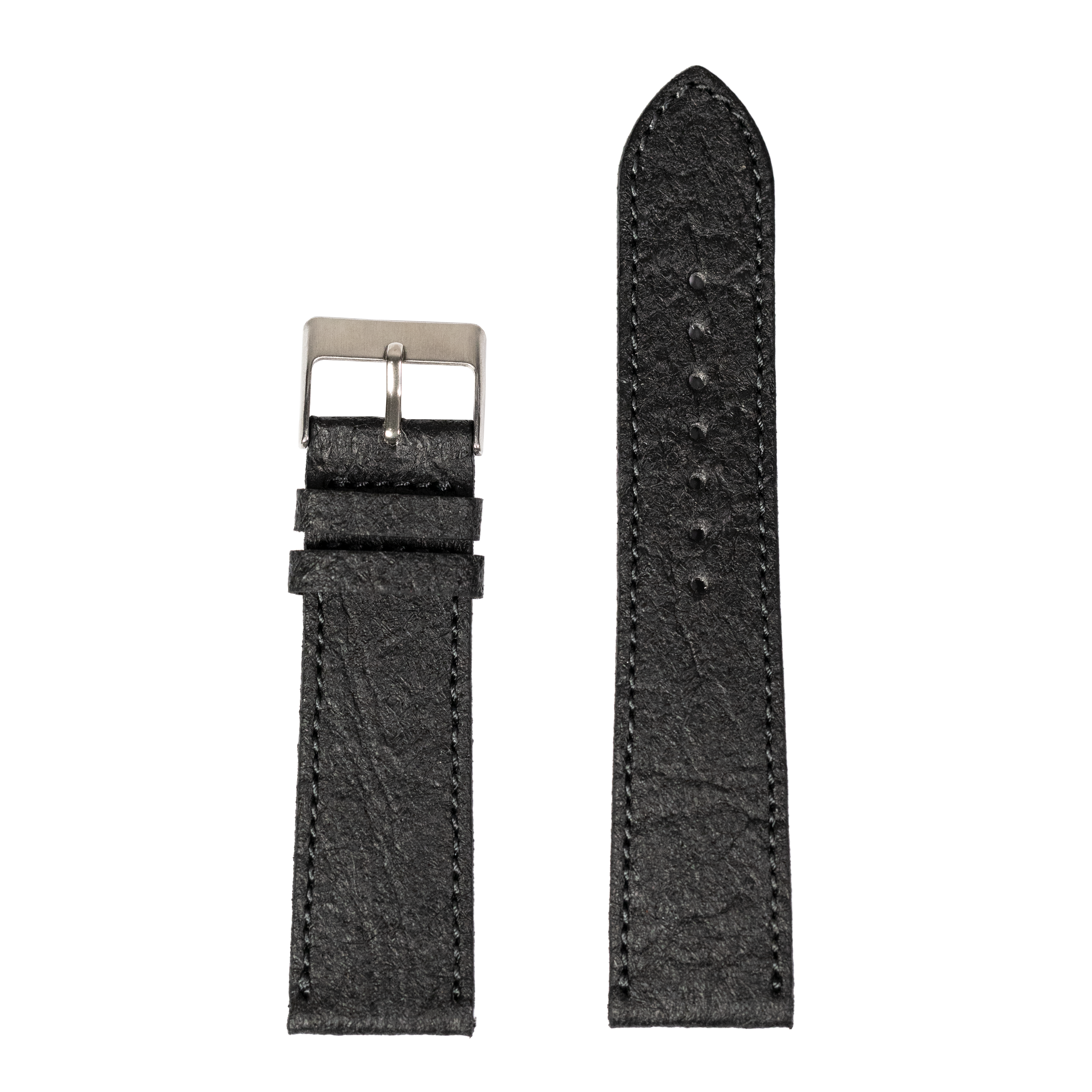 Black vegan leather quick release watch band with pineapple texture and silver buckle, shown fully extended and coiled