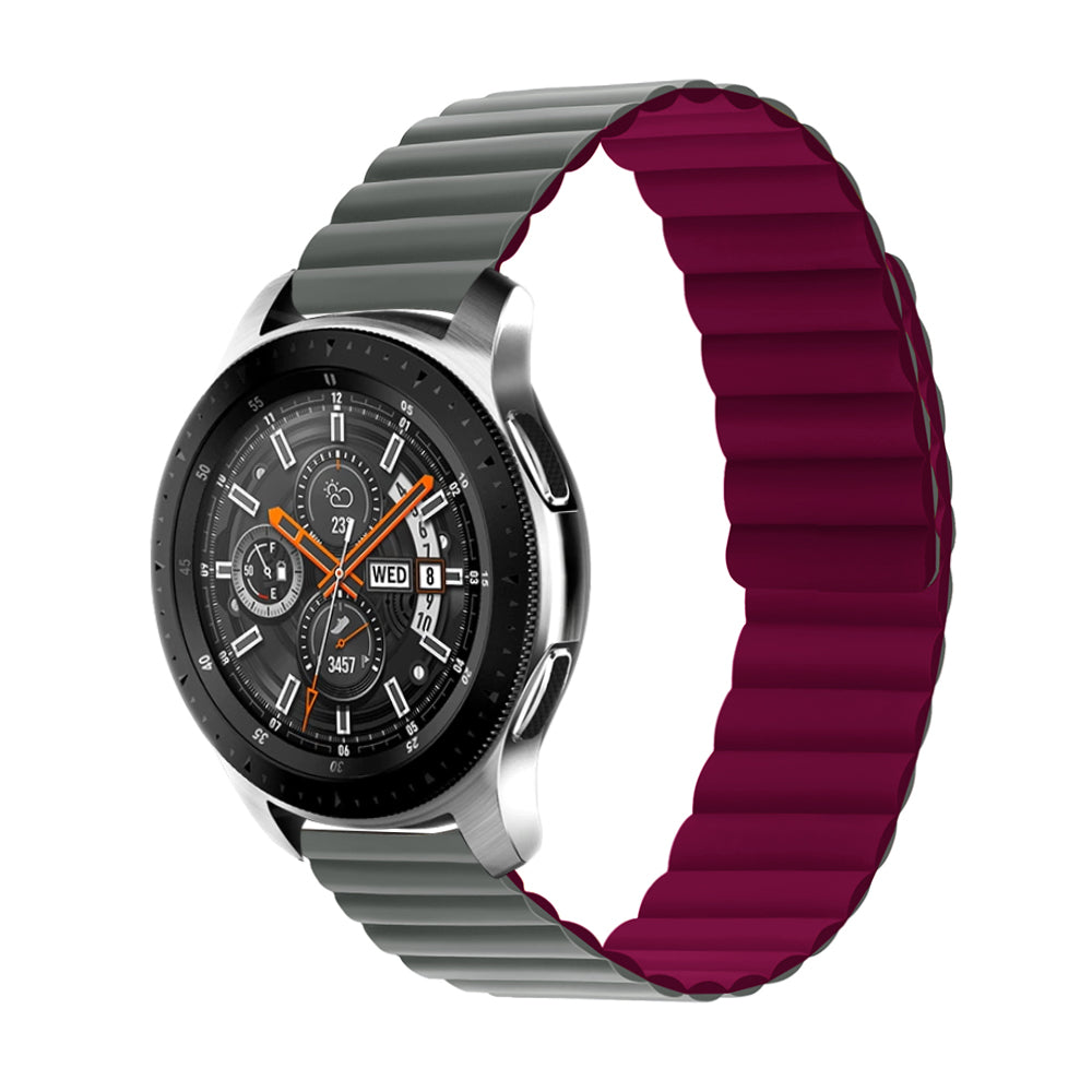 Smartwatch with black dial and orange accents, featuring gray silicone band and reversible burgundy magnetic loop strap