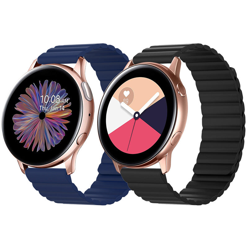 Two rose gold smartwatches with quick release magnetic silicone loop bands in navy blue and black, displaying watch faces with flower and pie chart designs