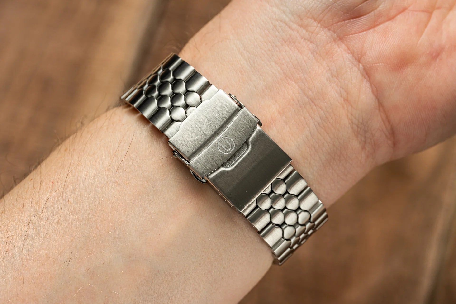 Stainless steel snakeskin textured watch bracelet with straight end links, shown worn on wrist in 18mm, 20mm, 22mm size options
