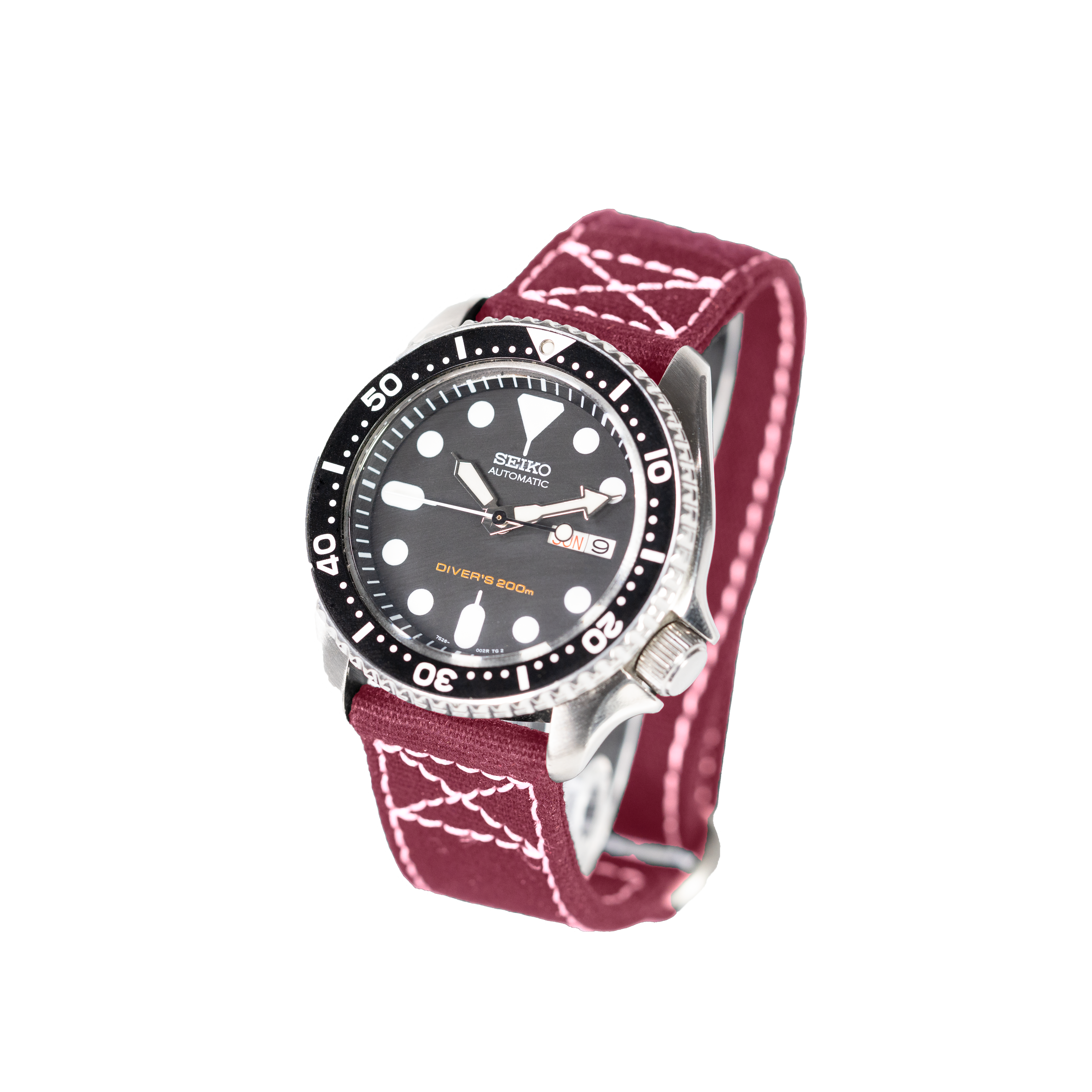 Seiko automatic diver's watch with black dial, stainless steel case, and wine red fabric strap with white stitching detail